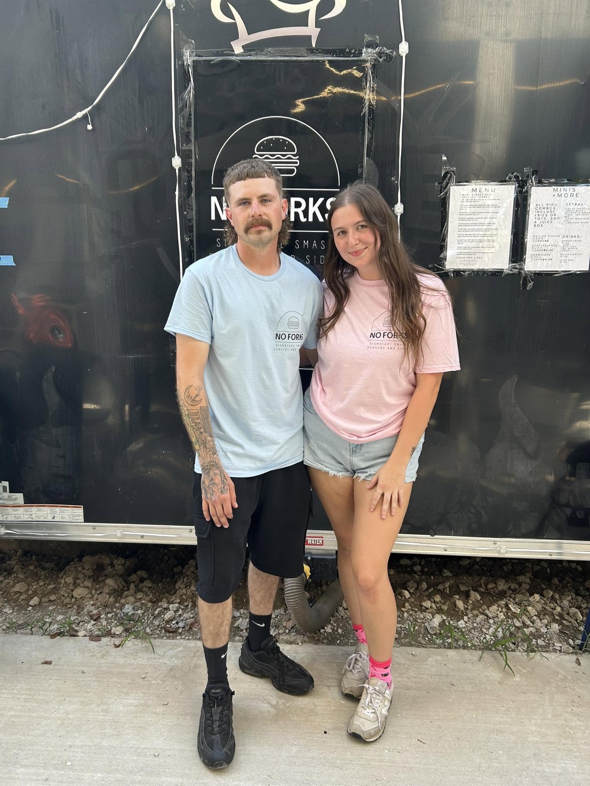 No Forks owners standing in front of the original food trailer